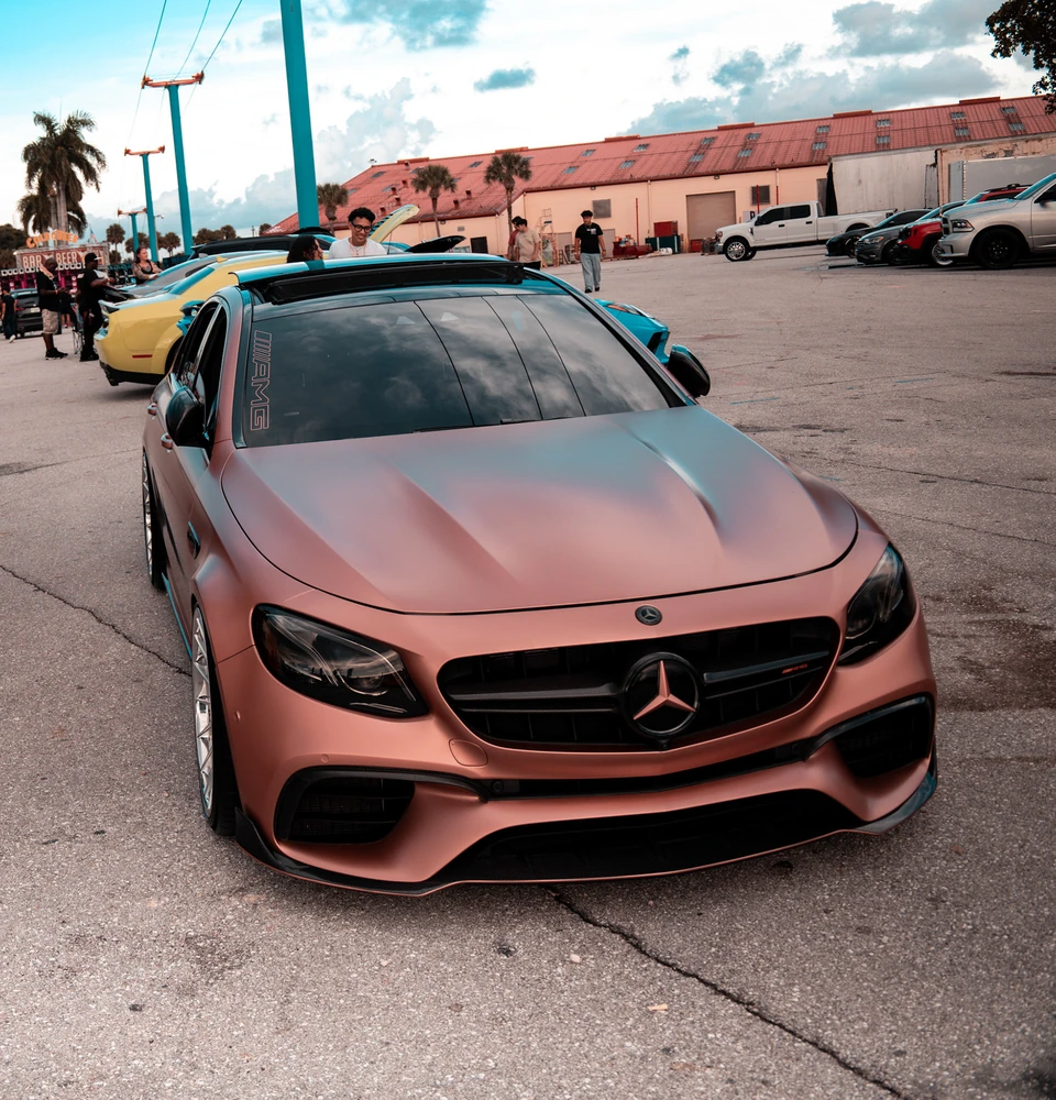 Satin copper Mercedes at an outdoor car gathering
